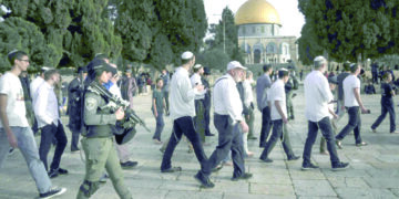 Palestinian teen killed in army raid as settlers hold march