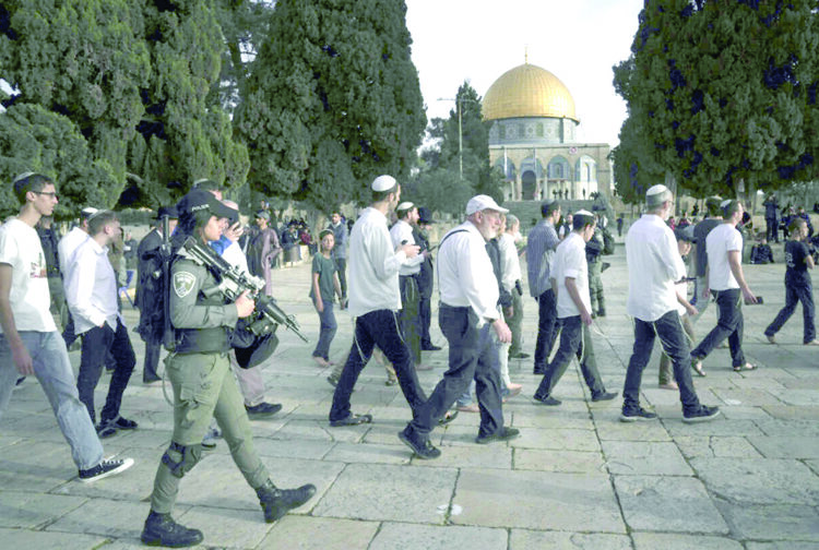 Israeli police escorting Jewish visitors marking the holiday of Passover to the Al-Aqsa Mosque compound.