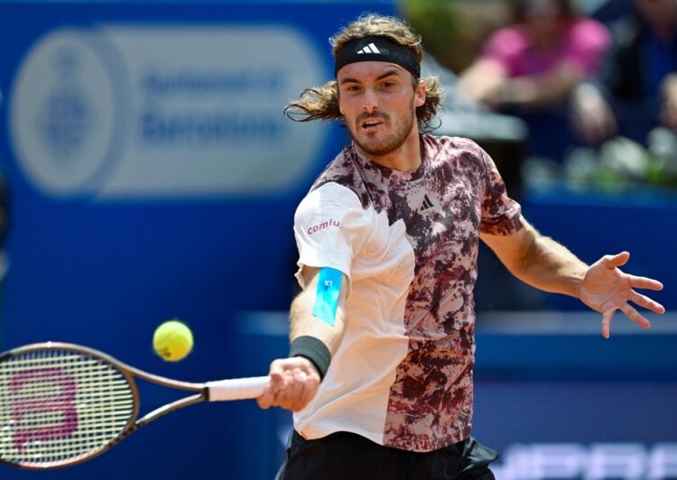 Greek tennis player Stefanos Tsitsipas returns the ball to Australian tennis player Alex de Minaur during the ATP Barcelona Open ‘Conde de Godo’ tennis tournament in Barcelona April 22, 2023.