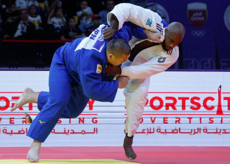 France's Teddy Riner (R) competes with Russia's Inal Tasoev during the men's +100Kg final bout at the World Judo Championship in Doha.