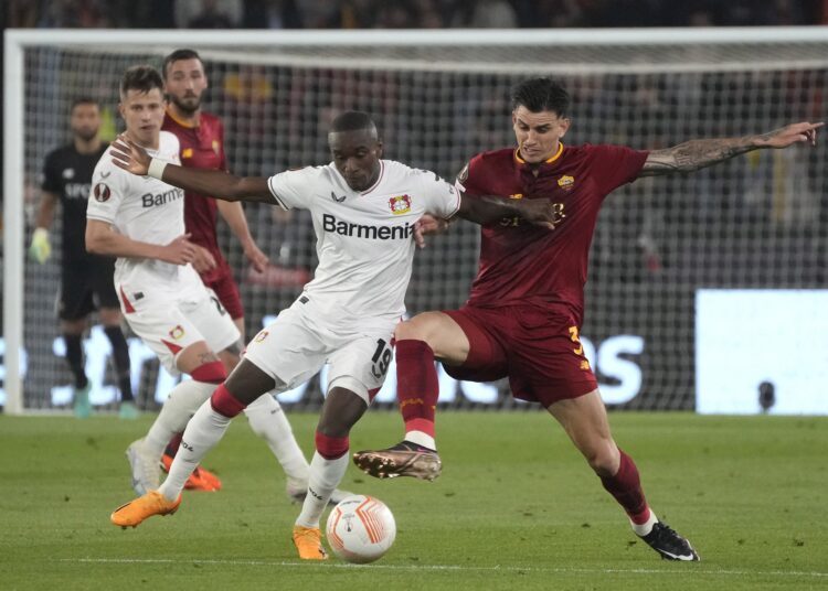 Roma's Roger Ibanez (R) and Leverkusen's Moussa Diaby vie for the ball during the UEFA Europa League semi-final first-leg match.