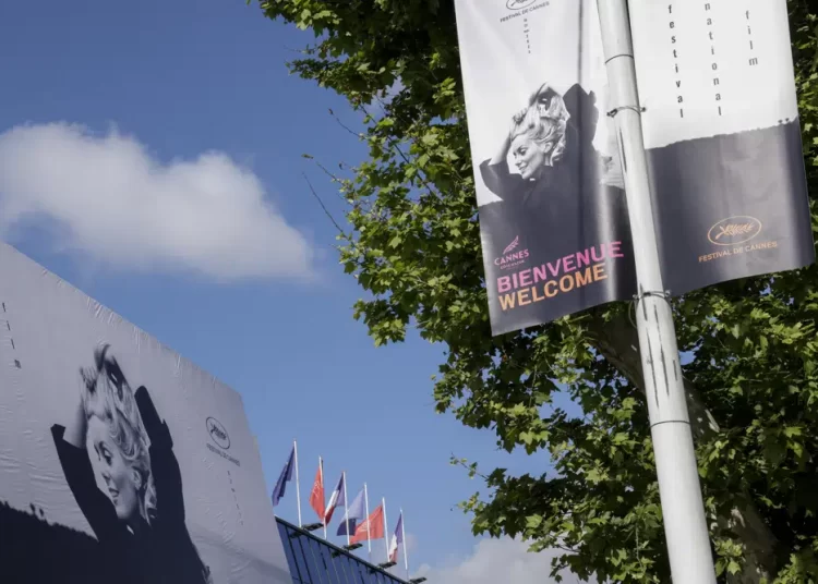 The official poster featuring actress Catherine Deneuve from the film 'La Chamade' is pictured on the facade of the Palais des Festivals ahead of the Cannes film festival, in Cannes, southern France, Monday, May 15, 2023.