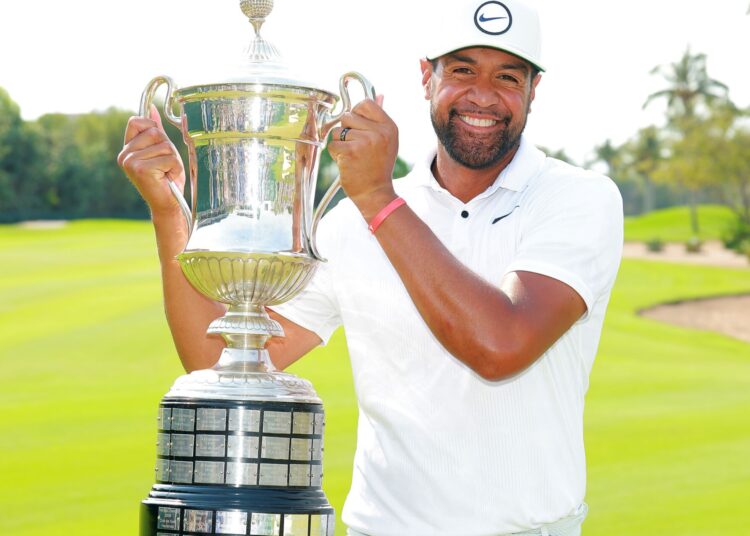 Tony Finau of the United States holds the championship trophy after winning the Mexico Open golf tournament in Puerto Vallarta, Mexico.