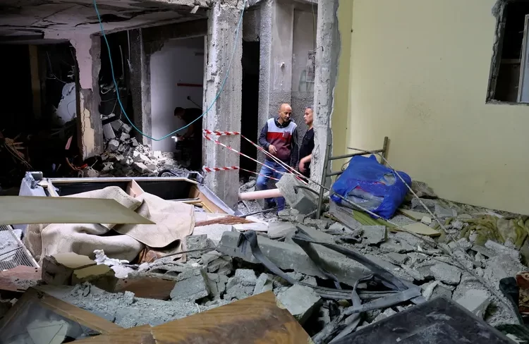 Abu Rudeineh: Describes Israeli raid in Nablus ‘a real massacre’ 1 - Egyptian Gazette Palestinians inspect a house damaged during an Israeli raid, in Balata camp, in the West Bank city of Nablus on Monday.