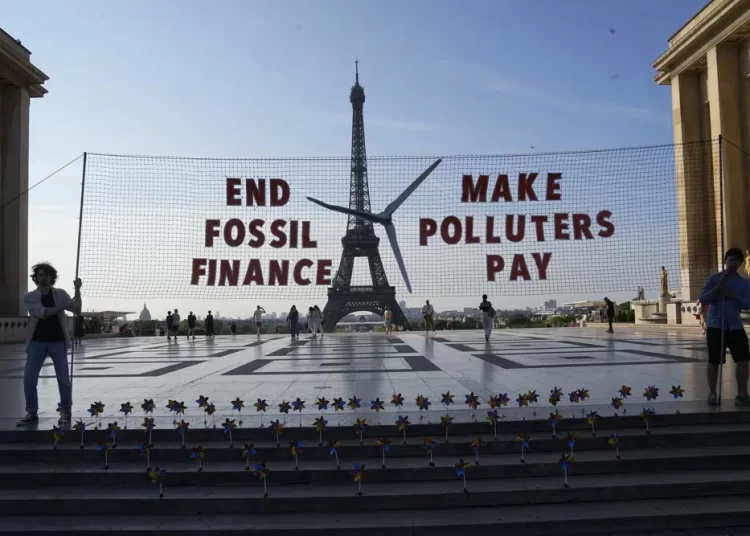 Climate activists stage a demonstration and transform the Eiffel Tower into a wind turbine ahead of the Global Climate Finance Summit, Wednesday, June 21, 2023 in Paris. Heads of state, finance leaders and activists from around the world will converge in Paris this week for a summit aimed at discussing how to overhaul the world's development banks — like the World Bank and IMF— and usher them into a post-pandemic world with a rapidly changing climate.