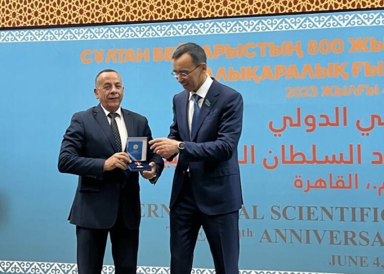 Supreme Council of Antiquities Secretary General Mostafa Waziry (L) receiving the Order from Kazakhstan's Senate Chairperson Maulen Ashimbayev in Cairo on Sunday.