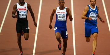 Hughes targets world glory after regaining 100m title