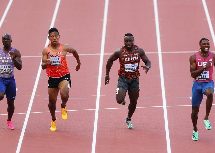 Noah Lyles, of the United States (R) crosses the line to win the gold medal in the men's 100-meters final during the World Athletics Championships in Budapest.