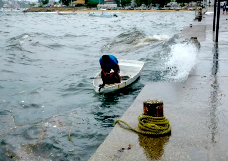 A man moors his boat in Acapulco on Mexico's Pacific coast as Hurricane Hilary strengthened offshore.