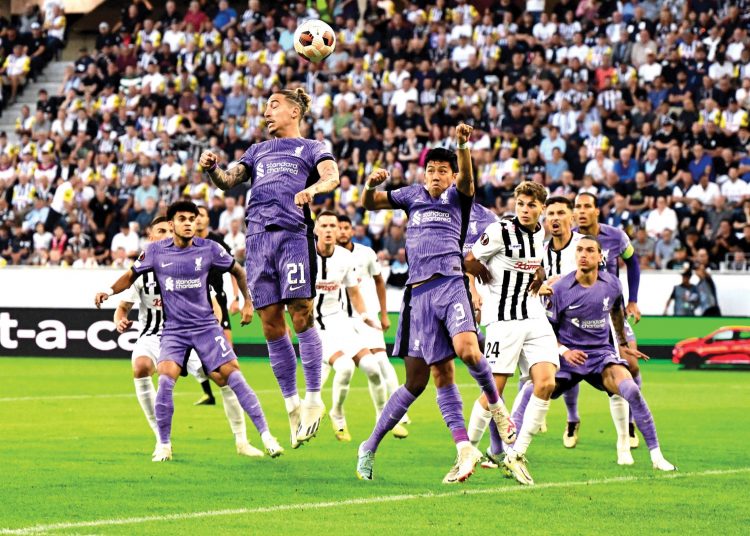 Liverpool's Greek defender Kostas Tsimikas heads the ball during the UEFA Europa League Group E match against Linzer ASK September 21, 2023.