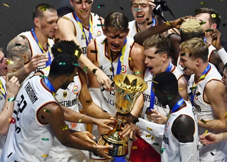 Germany’s players celebrate with the trophy after winning the Basketball World Cup championship.