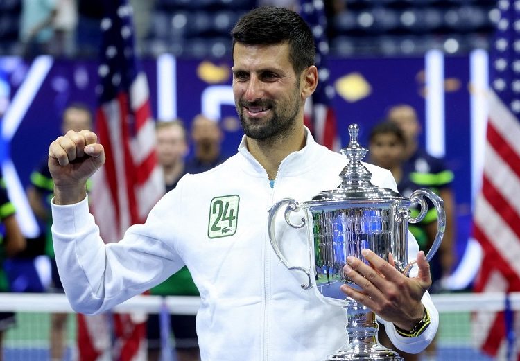 Novak Djokovic holds up the trophy after winning the US Open tennis championships.