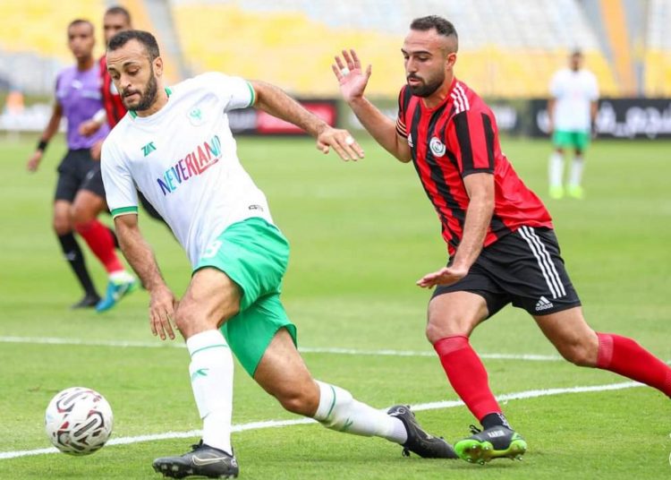 Al-Masry’s striker Marwan Hamdi (L) controls the ball against El- Dakhleya defender at Borg el-Arab Stadium in Alexandria.