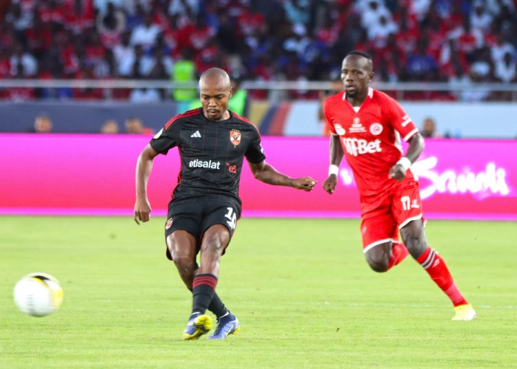 Al-Ahly’s South African winger Percy Tau (L) passes the ball under pressure from Simba’s Clatous Chama during the first fixture of the inaugural African Football League.