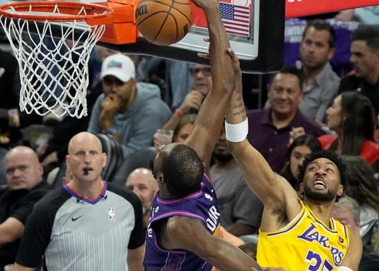 Phoenix Suns Kevin Durant (L) shoots as Los Angeles Lakers Christian Wood defends during an NBA basketball in-season tournament game in Phoenix.
