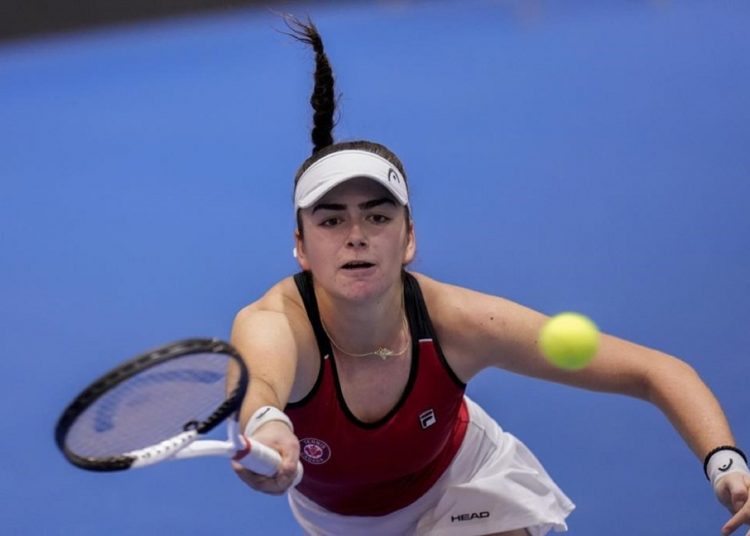 Canada's Marina Stakusic returns the ball to Poland's Magdalena Frech during their group stage tennis match at the Billie Jean King Cup finals.