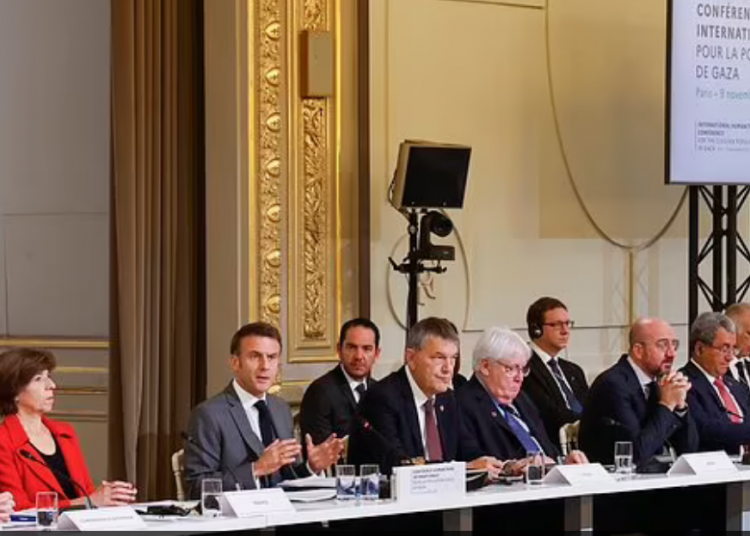 French President Emmanuel Macron, center, speaks during a meeting with officials from Western and Arab nations, the United Nations and nongovernmental organizations at the Elysee Palace, in Paris
