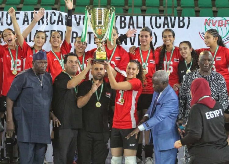Egypt Girls U-17 team players celebrate with the trophy after winning the African Nations Volleyball Championship.