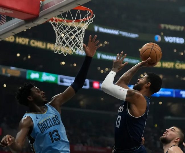 Memphis Grizzlies Jaren Jackson Jr. (L) blocks Los Angeles Clippers Paul George (C) during the first half of an NBA basketball game in Los Angeles.