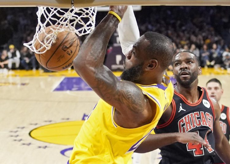 Los Angeles Lakers LeBron James dunks as Chicago Bulls forward Patrick Williams defends during their NBA basketball game.