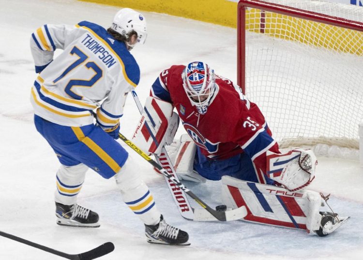 Montreal Canadiens goaltender Sam Montembeault (R) makes a save against Buffalo Sabres' Tage Thompson during an NHL hockey game in Montreal.