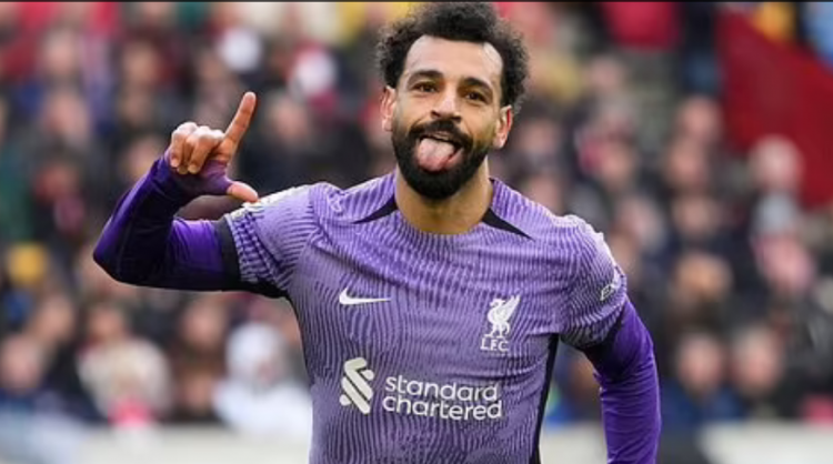 Liverpool's Mohamed Salah celebrates scoring his sides third goal during the English Premier League soccer match between Brentford and Liverpool at the Gtech Community Stadium in London.
