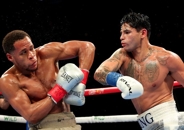 Ryan Garcia (R) knocks down Devin Haney during a super lightweight boxing match on April 21, 2024, in New York. Garcia won the fight.