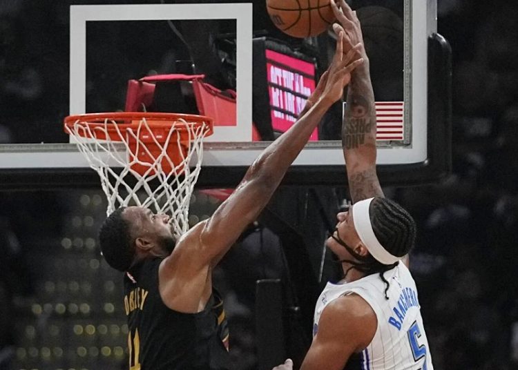 Orlando Magic Paolo Banchero (5) is fouled by Cleveland Cavaliers Evan Mobley (4) in Game 7 of an NBA basketball first-round playoff.