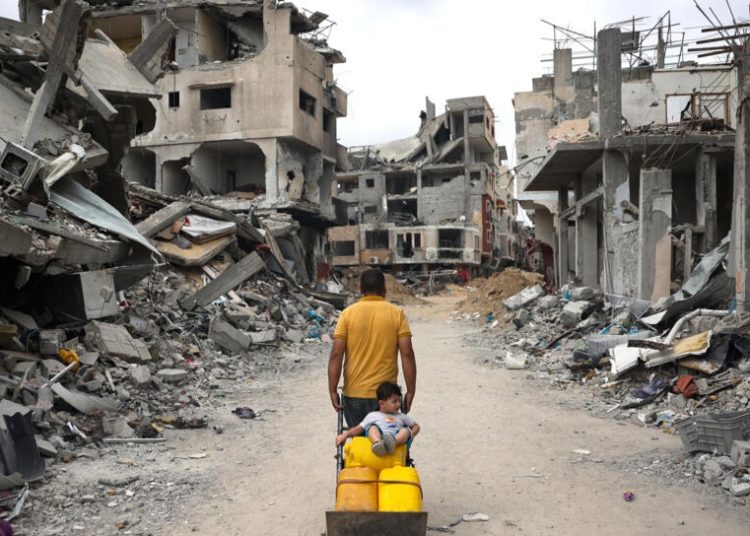 Gaza needs biggest post-war reconstruction effort since WWII: UN 1 - Egyptian Gazette A Palestinian pulls a cart past destroyed buildings in Khan Yunis in southern Gaza.