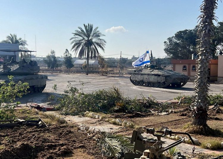 FILE PHOTO: Israeli military vehicles operate in the Gazan side of the Rafah Crossing, amid the ongoing conflict between Israel and Palestinian Islamist group Hamas, in the southern Gaza Strip, in this handout image released on May 7, 2024. Israel Defense Forces/Handout via REUTERS/File Photo