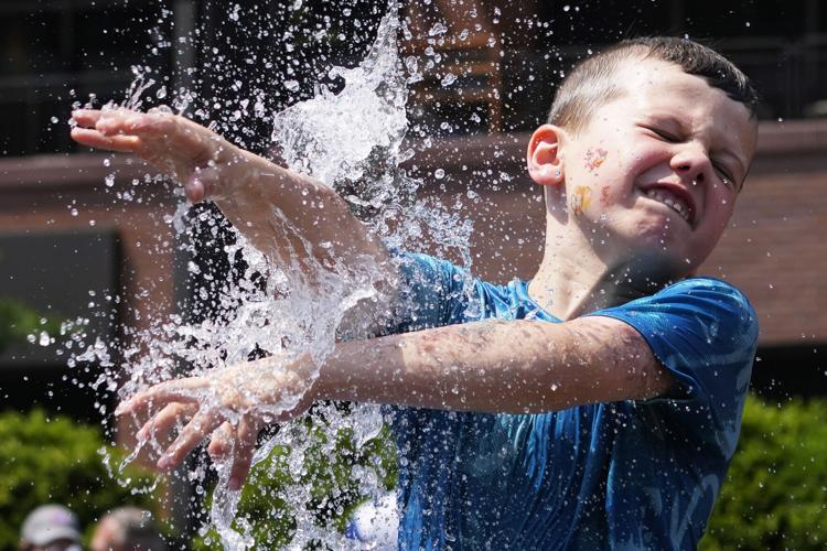 Tens of millions in US remain under dangerous heat warnings 1 - Egyptian Gazette A boy cools off at a fountain outside Wrigley Field before a baseball game between the Chicago Cubs and St. Louis Cardinals as hot weather descends upon the Chicago area.