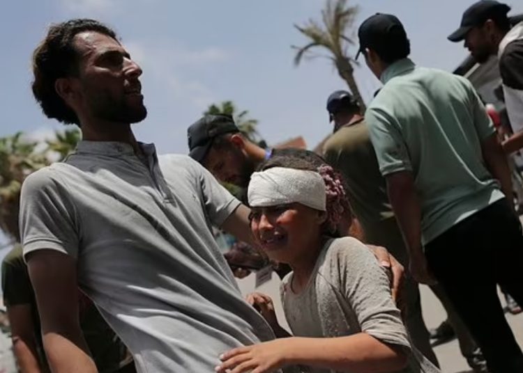 President Abbas seeks emergency UNSC session following Nuseirat massacre 1 - Egyptian Gazette Palestinians wounded in the Israeli bombardment of the Gaza Strip arrive at al-Aqsa Hospital in Deir al Balah