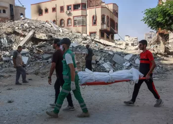 Emergency workers uncover dozens of bodies in a Gaza City district after Israeli assault