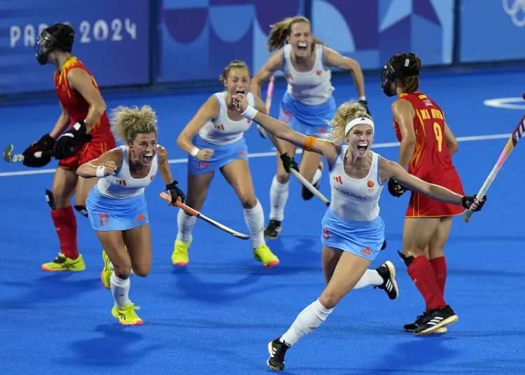 Netherlands’ players celebrate after scoring against China during the women's gold medal hockey match in Colombes, France.