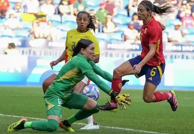 Colombia's goalkeeper Katherine Tapia blocks a goal attempt by Spain's Aitana Bonmati (R) during the women's quarter-final soccer match during the 2024 Summer Olympics.