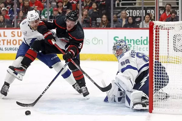 Canucks drop shootout to Flyers 1 - Egyptian Gazette Carolina Hurricanes' Andrei Svechnikov (C) battles with Tampa Bay Lightning's Erik Cernak (L) for the puck in front of Lightning goaltender Andrei Vasilevskiy during an NHL hockey game in Raleigh.