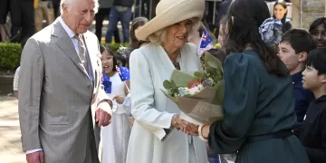 Children greet King Charles III and Queen Camilla outside a Sydney church
