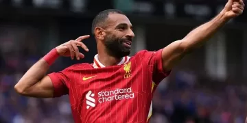 Salah strike sends Liverpool top