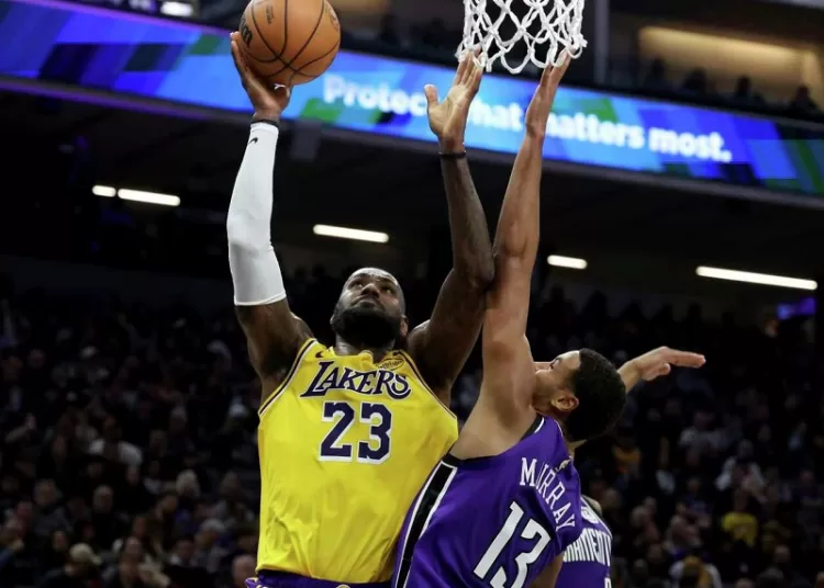 Los Angeles Lakers LeBron James (L) shoots against Sacramento Kings Keegan Murray during their NBA basketball game.