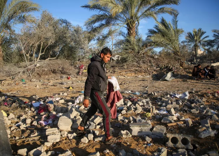 A Palestinian man inspects the site of an Israeli strike on a house, amid the ongoing conflict between Israel and Hamas, in Khan Younis in the southern Gaza Strip, January 14, 2025