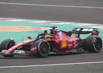 Lewis Hamilton waves to fans as he drives a Ferrari F1 car for the first time