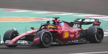 Lewis Hamilton waves to fans as he drives a Ferrari F1 car for the first time