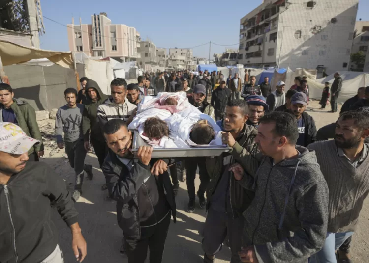 FILE - The bodies of three children killed by an Israeli strike are carried for burial in Khan Younis, Gaza Strip, Thursday Nov. 21, 2024. (AP Photo/Abdel Kareem Hana, File)