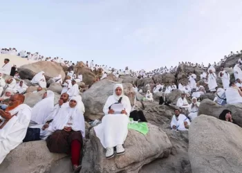 Pilgrims climbing Mount Arafat during Hajj