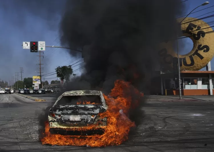 Trump deploys guard to LA amid immigration protests 1 - Egyptian Gazette A car burns during a protest in Compton, Calif., Saturday, June 7, 2025, after federal immigration authorities conducted operations.