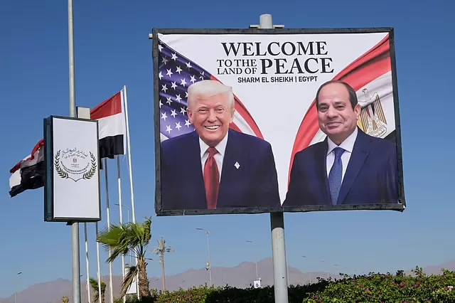 Israeli media: Egypt’s regional influence rises after Gaza peace talks 1 - Egyptian Gazette This photograph shows a billboard bearing the portraits of US President Donald Trump and Egyptian President Abdel Fattah Al Sisi outside the convention centre ahead of the Sharm Al Sheikh Peace Summit in the Egyptian Red Sea resort town of Sharm Al Sheikh on October 13, 2025. AFP