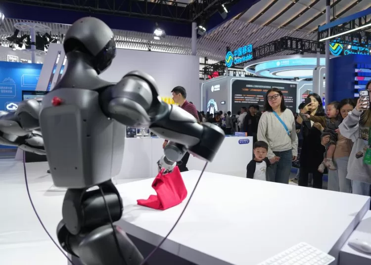 China moves forward with its "AI Plus" initiative 1 - Egyptian Gazette (251106) -- TONGXIANG, Nov. 6, 2025 (Xinhua) -- A humanoid robot demonstrates its skill of folding a cloth at the 2025 World Internet Conference (2025 WIC) Light of Internet Expo in Wuzhen, east China's Zhejiang Province, Nov. 6, 2025. The expo kicked off here on Thursday, showcasing more than 1,000 cutting-edge AI technology products from over 600 domestic and overseas enterprises. (Xinhua/Huang Zongzhi)
