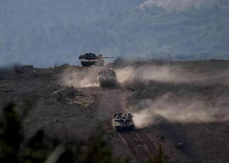 Lebanese army members stand on a military vehicle during a Lebanese army media tour, to review the army's operations in the southern Litani sector, in Alma Al-Shaab, near the border with Israel, southern Lebanon, November 28, 2025.