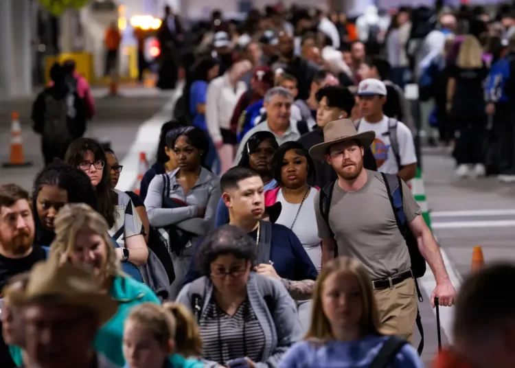 Travelers waiting in line at a Transportation Security Administration (TSA) checkpoint at William P. Hobby Airport in Houston, Texas, US, on Monday, March 9, 2026.