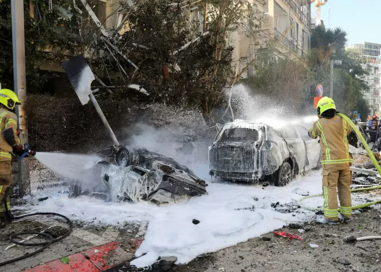 Iran hits Israel with missile waves, dismisses Trump’s talks as ‘fake news’ 11 - Egyptian Gazette Israeli firefighters work to put out a fire following Iranian missile strikes on Israel, March 24, 2026. REUTERS/